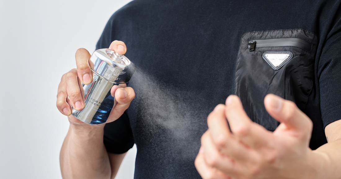 Man spraying a luxurious pheromone cologne onto his neck.